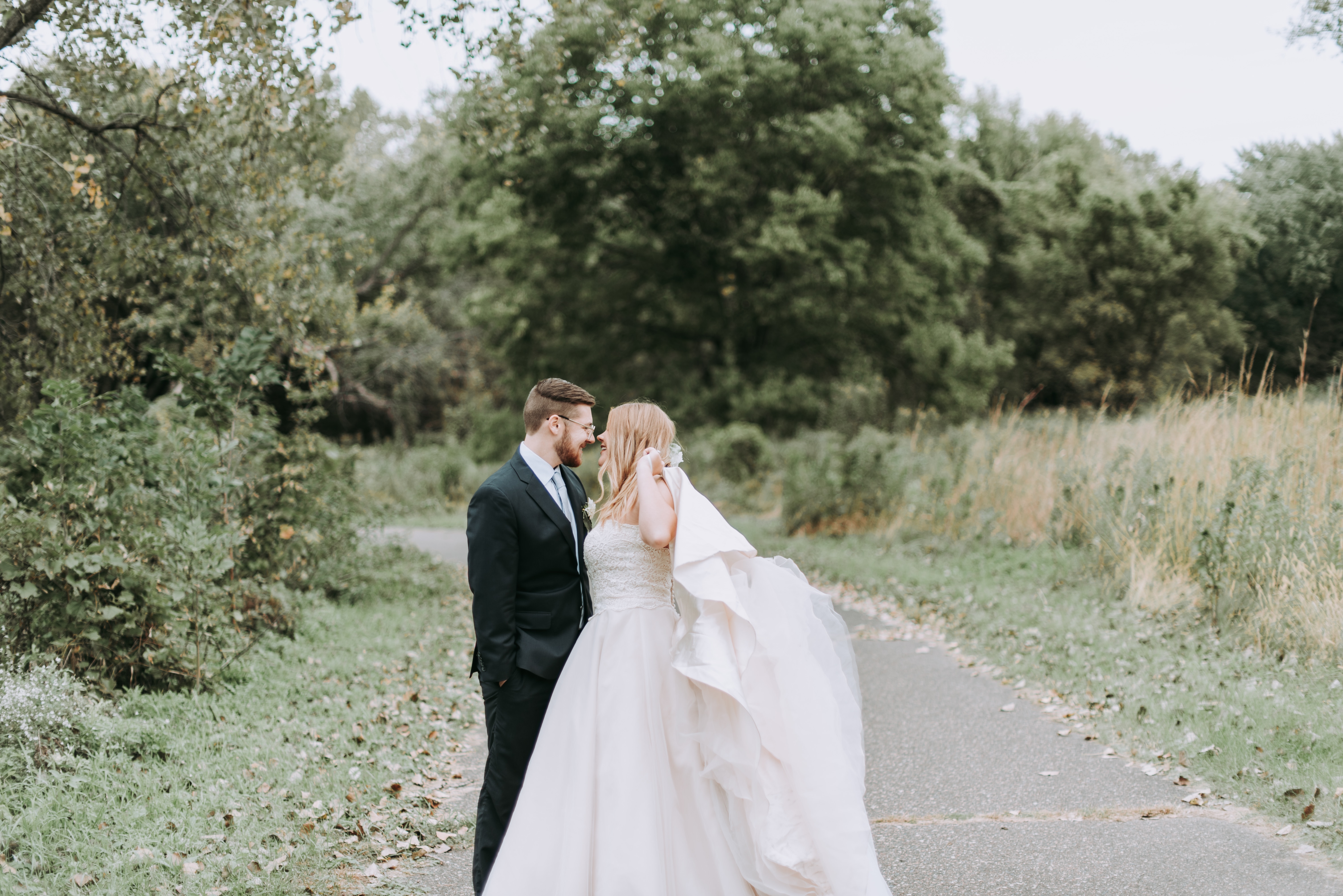 bride and groom along a trail