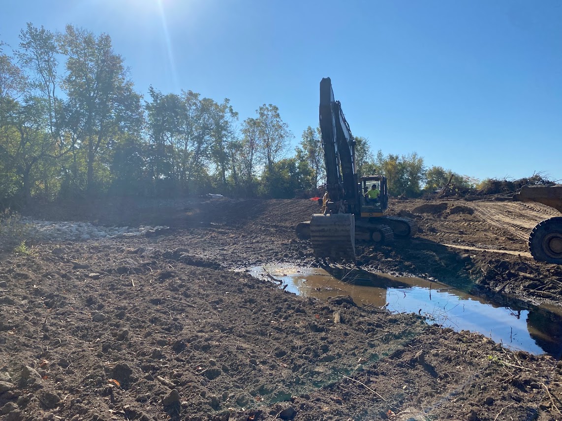 Backhoe moving dirt