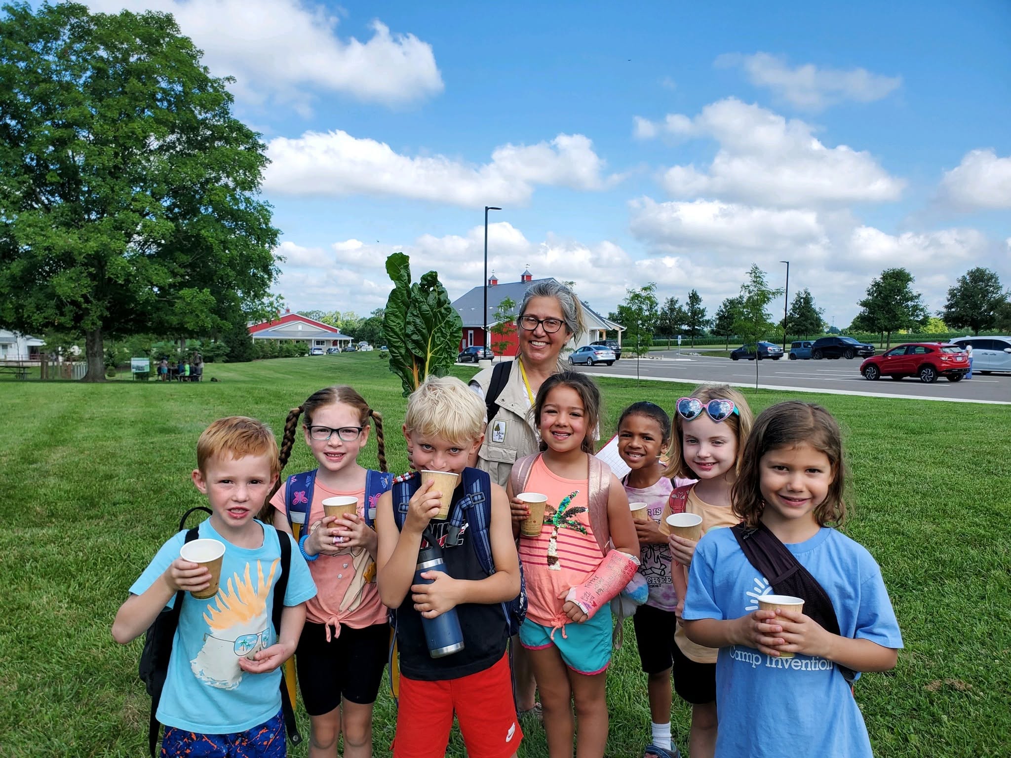 Children posing with the naturalist at an eco splorers summer camp
