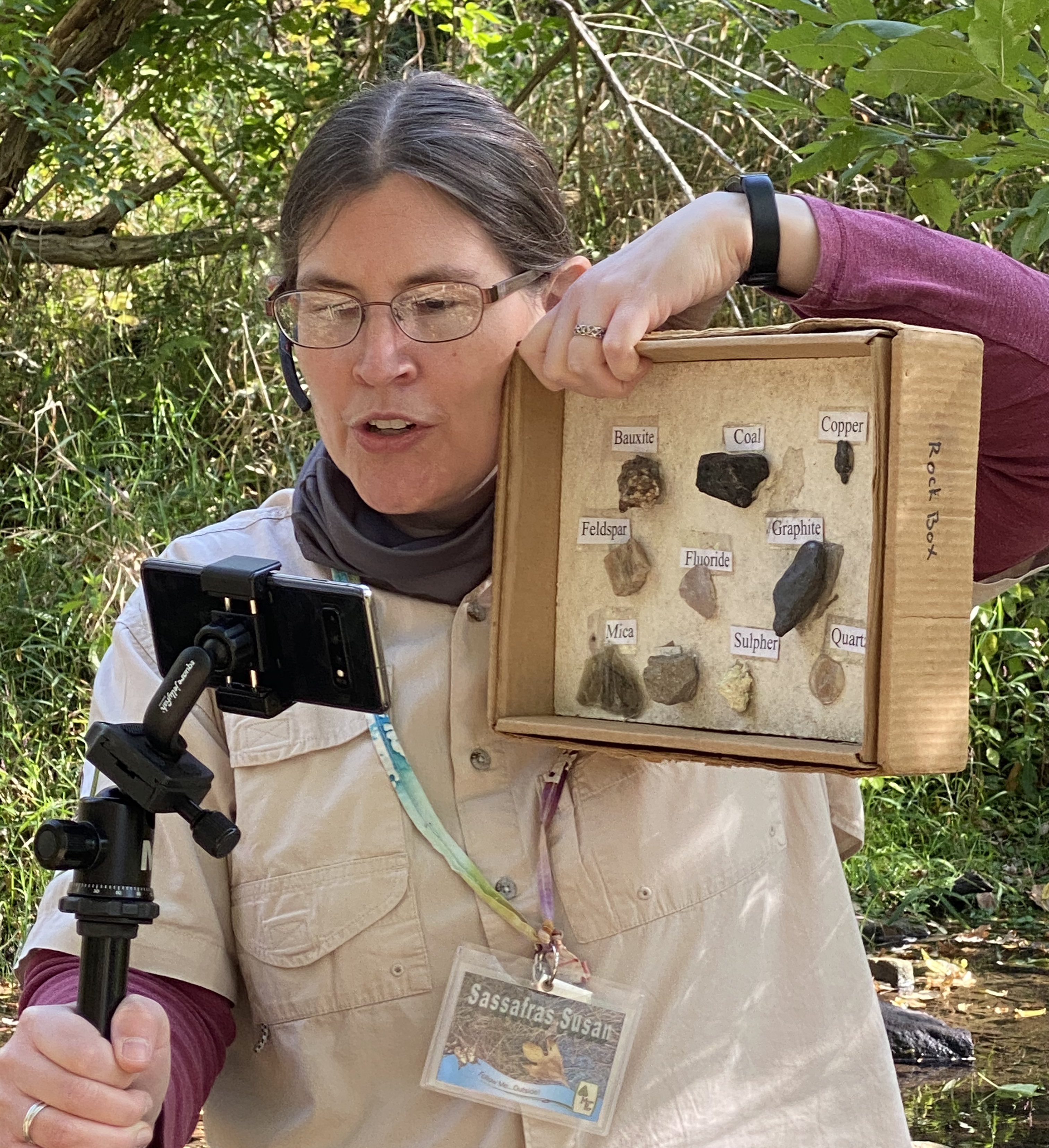 Naturalist showing a box of labeled rocks