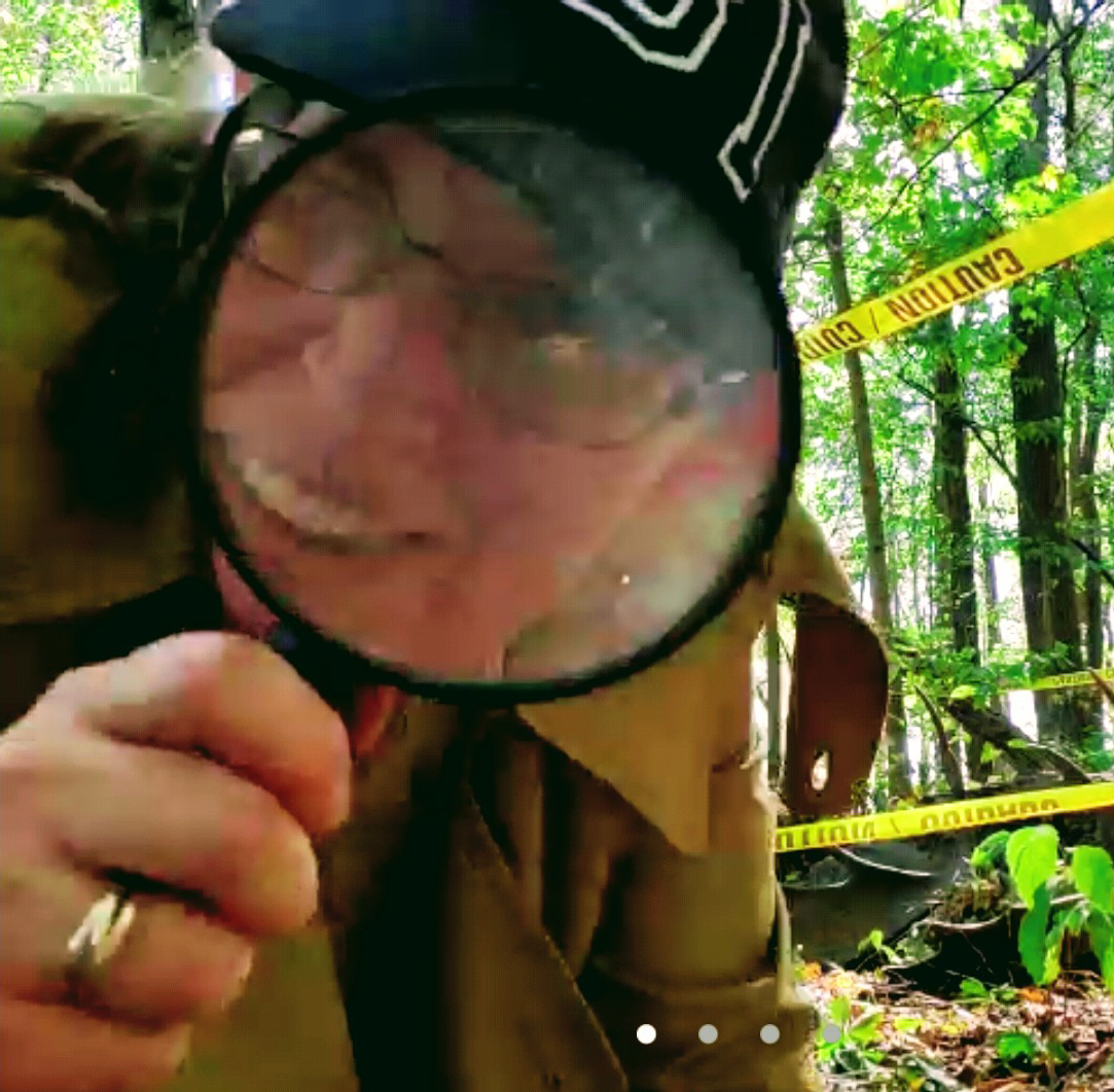 Naturalist looking through a magnifying glass