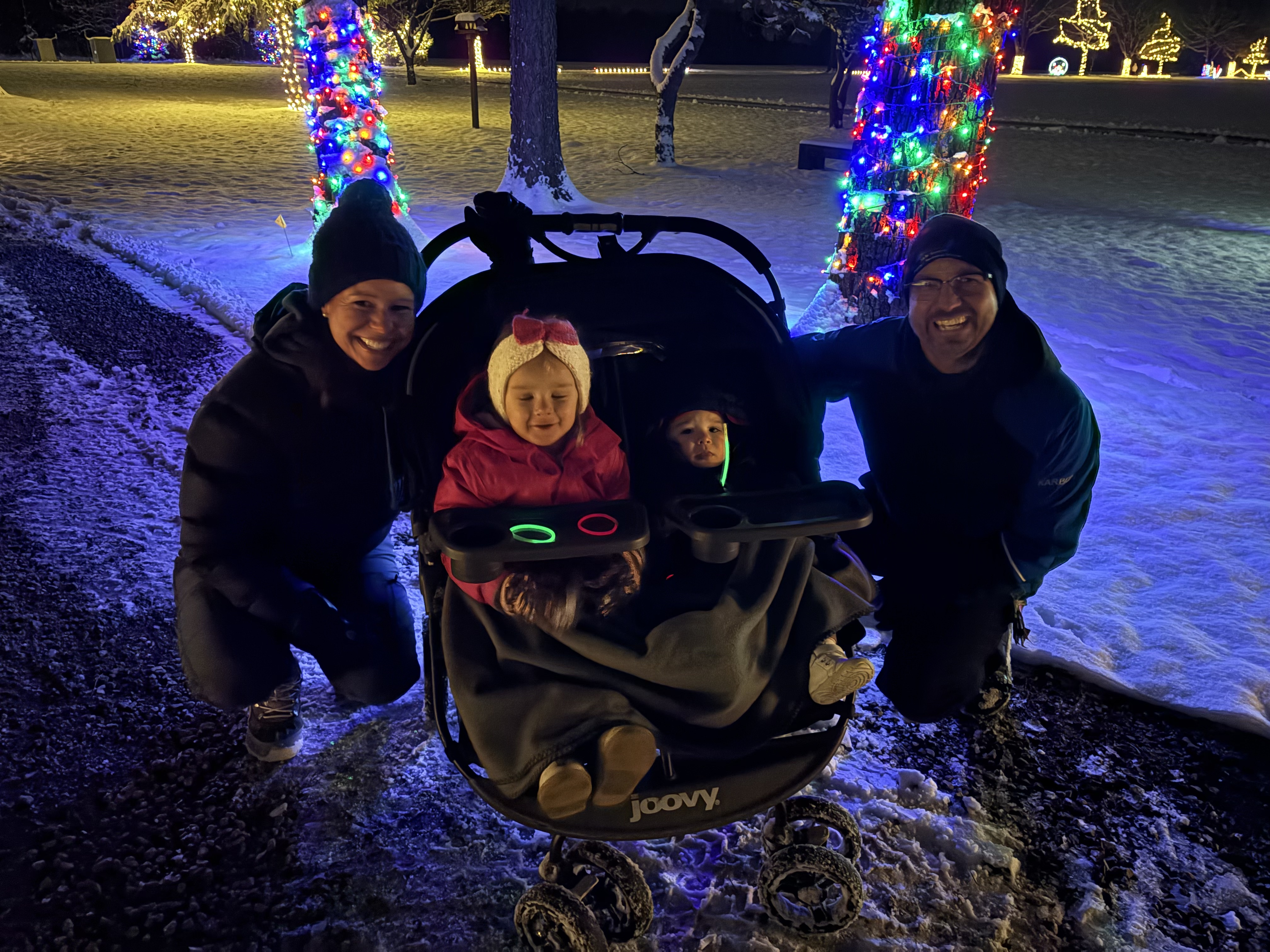 Family with a stroller at Holiday Lights at Lost Creek Reserve
