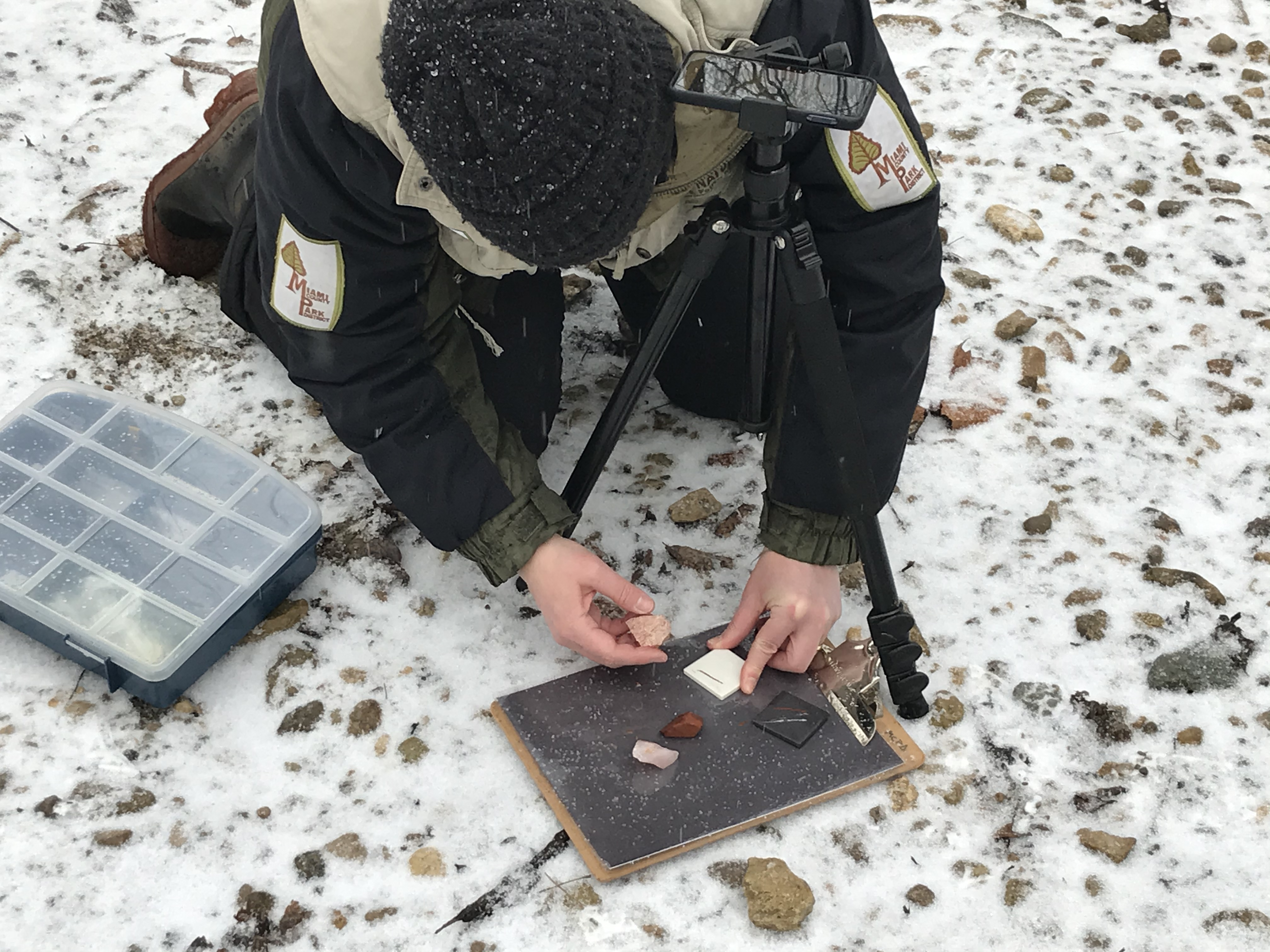 Naturalist showing rocks on camera