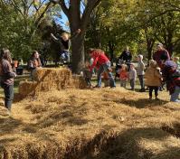 boy jumping off hay bale