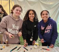 three girls painting rocks