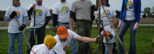volunteers planting a tree