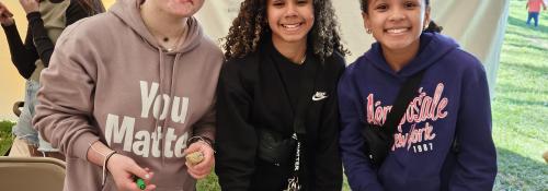 three girls painting rocks