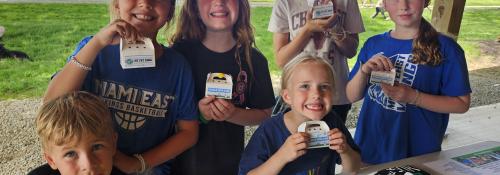 Kids holding up their handmade crafts