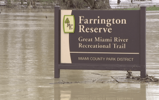 Farrington Reserve Sign nearly under water due to flooding.